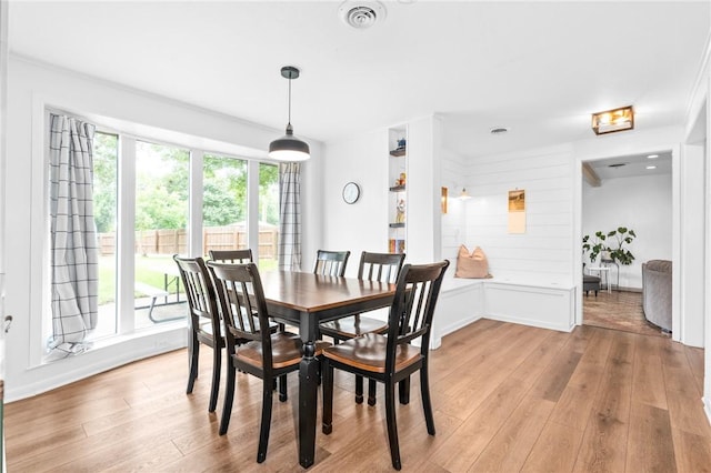 dining room featuring light hardwood / wood-style flooring and a healthy amount of sunlight