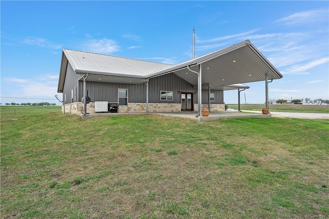 back of house with a yard and a patio