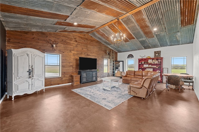 living room featuring wooden ceiling, high vaulted ceiling, wood walls, a chandelier, and concrete flooring