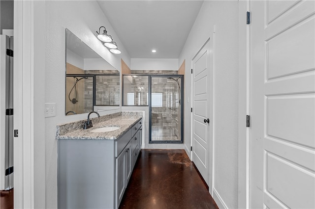 bathroom featuring vanity, concrete floors, and walk in shower