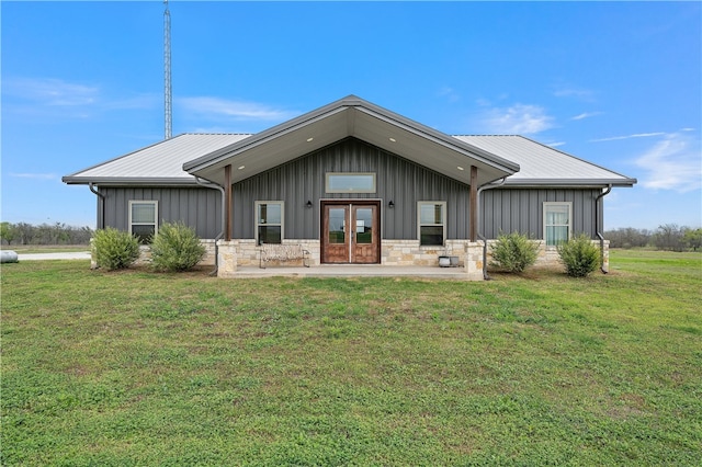 rear view of property with a yard