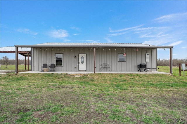 rear view of property featuring a yard and a patio