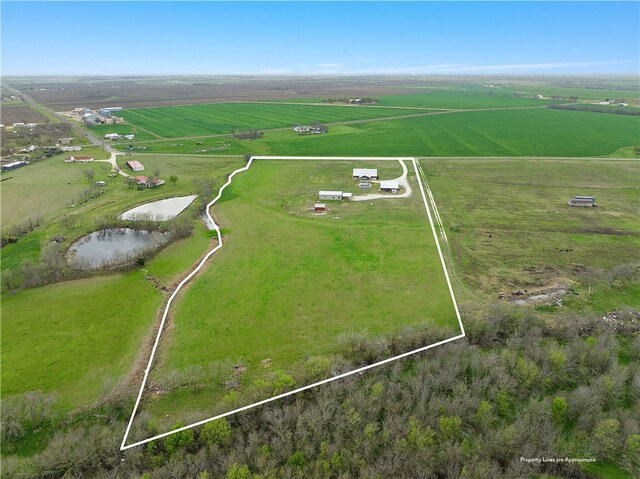 birds eye view of property with a water view and a rural view