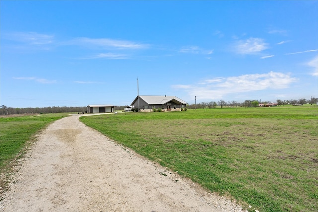 view of community featuring a yard and a rural view