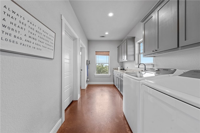 laundry area featuring cabinets and washer and clothes dryer