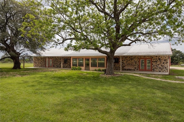 exterior space featuring french doors and a front lawn