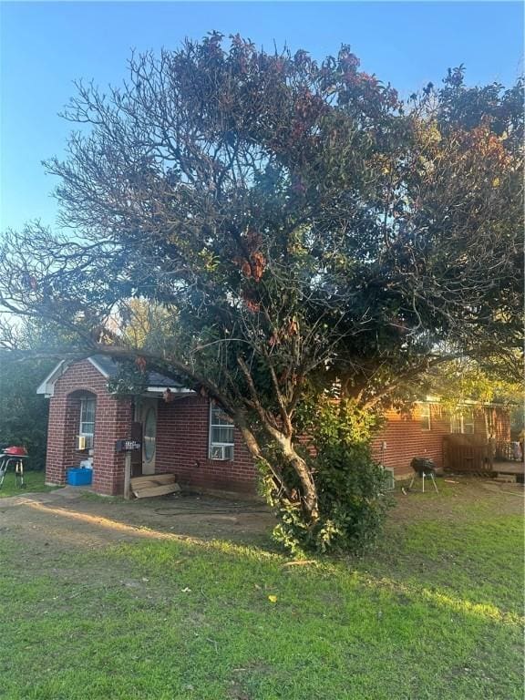 view of home's exterior with a yard and a patio