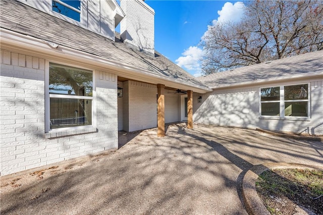 view of exterior entry featuring ceiling fan and a patio area