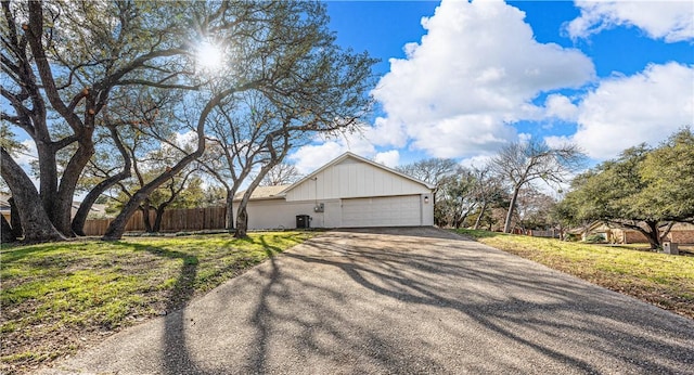 view of side of home featuring a garage and a yard