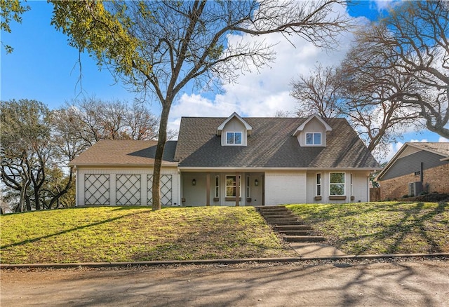 new england style home with a garage and a front yard