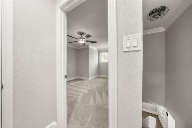 hallway featuring light colored carpet and ornamental molding