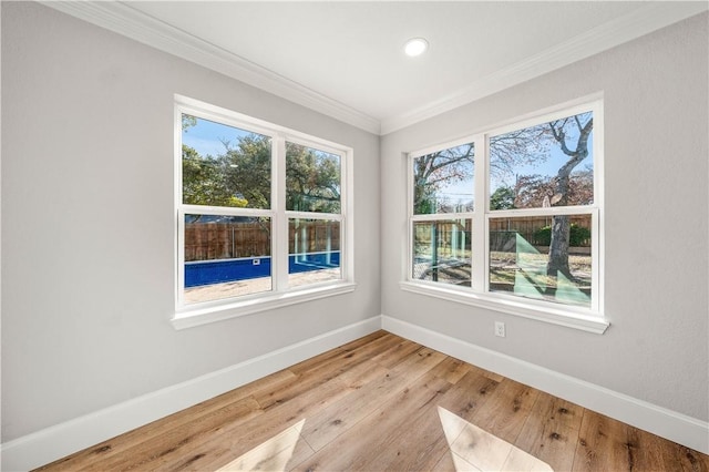 empty room featuring light hardwood / wood-style flooring and ornamental molding