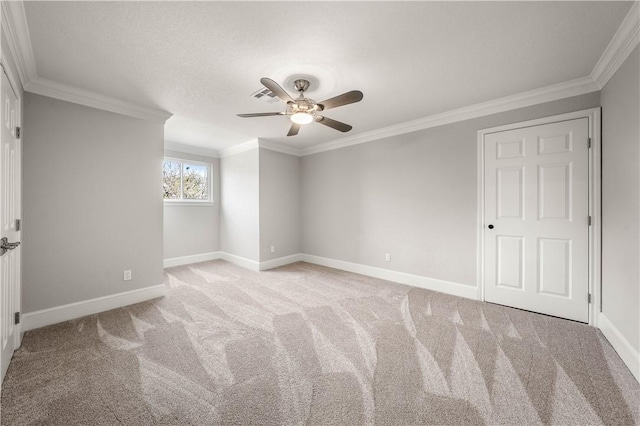 unfurnished room with ceiling fan, light colored carpet, and ornamental molding