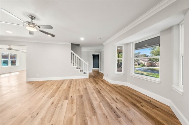 unfurnished living room with ornamental molding and light wood-type flooring