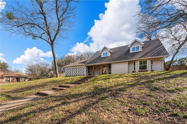 cape cod-style house featuring a front lawn