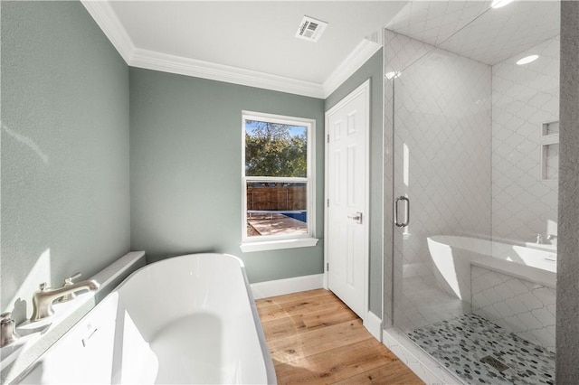 bathroom featuring hardwood / wood-style floors, ornamental molding, and plus walk in shower