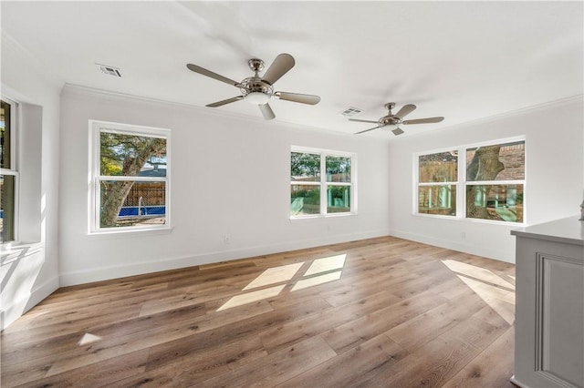 unfurnished room featuring crown molding, ceiling fan, and light wood-type flooring