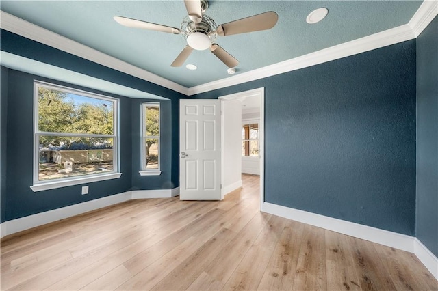 unfurnished bedroom featuring ornamental molding, ceiling fan, and light hardwood / wood-style flooring