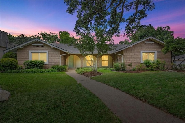 ranch-style house featuring a yard