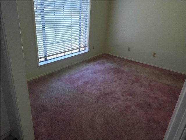 empty room featuring dark carpet