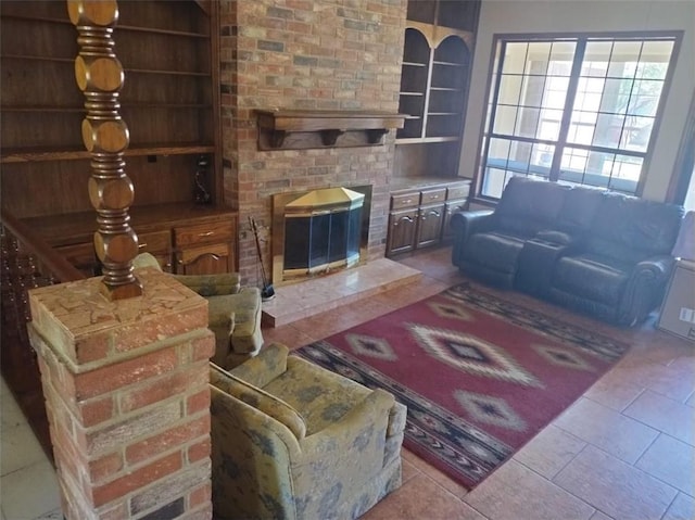 living room featuring light tile patterned floors and built in shelves