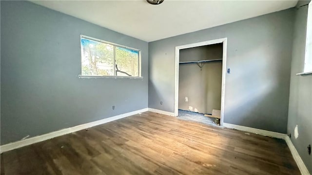 unfurnished bedroom featuring hardwood / wood-style flooring and a closet