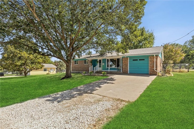 single story home featuring a porch, a garage, and a front lawn