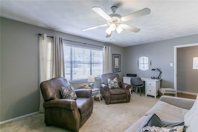 interior space with light carpet, ceiling fan, and baseboards