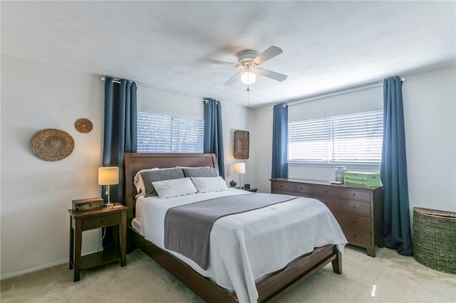 bedroom featuring baseboards, a ceiling fan, and light colored carpet