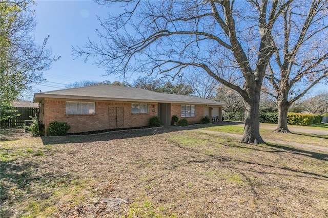 single story home with brick siding, a front lawn, an attached garage, and fence