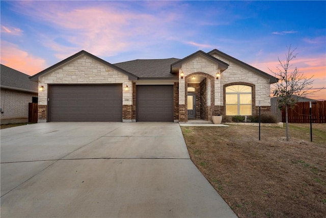 view of front facade featuring a garage and a lawn