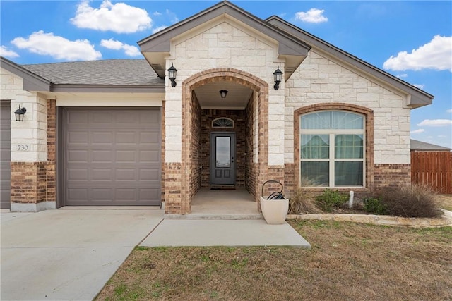 doorway to property with a garage and a yard