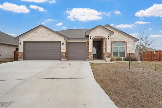 view of front of home with a front yard and a garage