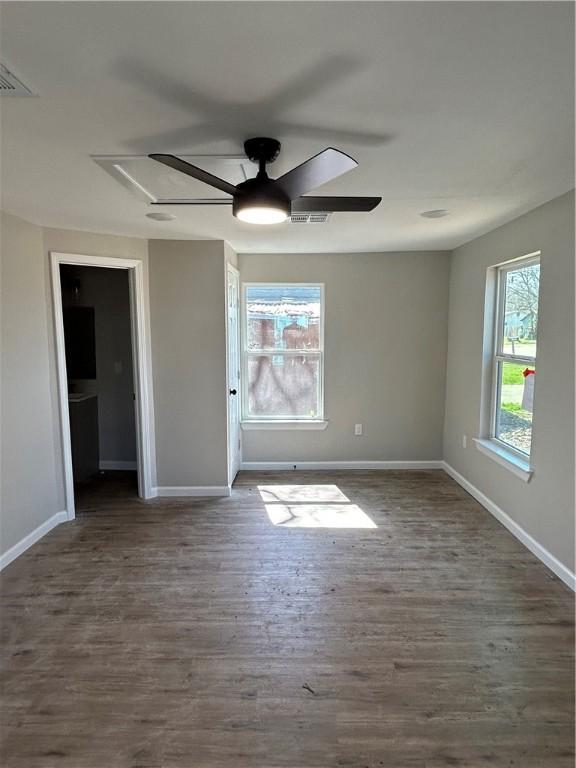 unfurnished room with dark hardwood / wood-style floors and ceiling fan