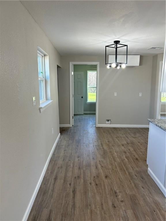 unfurnished dining area featuring dark hardwood / wood-style floors