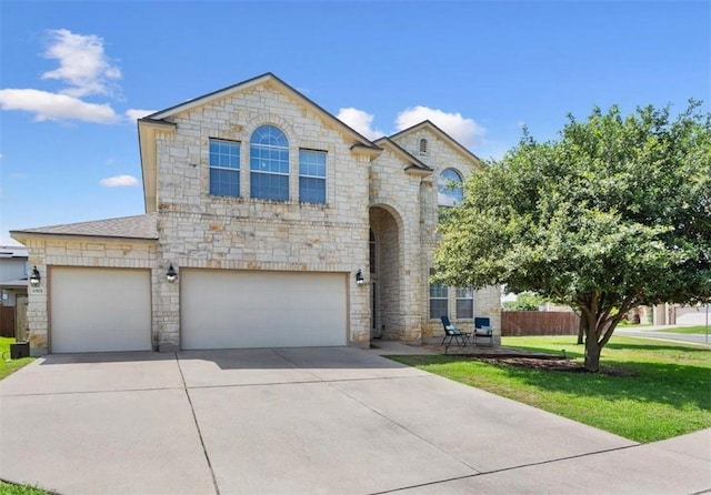 view of front of home with a front yard and a garage