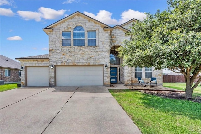 view of front of house featuring a garage and a front lawn