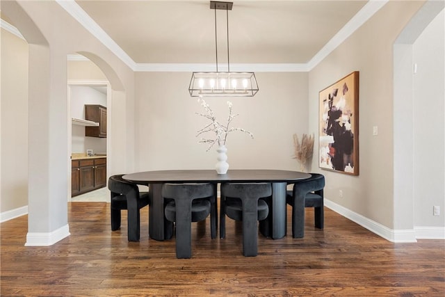 dining space with ornamental molding and dark hardwood / wood-style floors