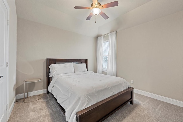 bedroom with vaulted ceiling, ceiling fan, and carpet floors