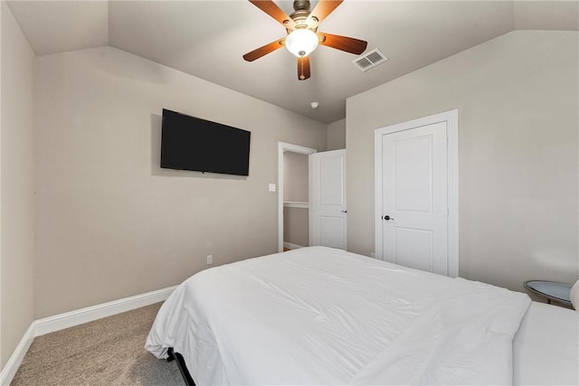 bedroom featuring vaulted ceiling, light colored carpet, and ceiling fan