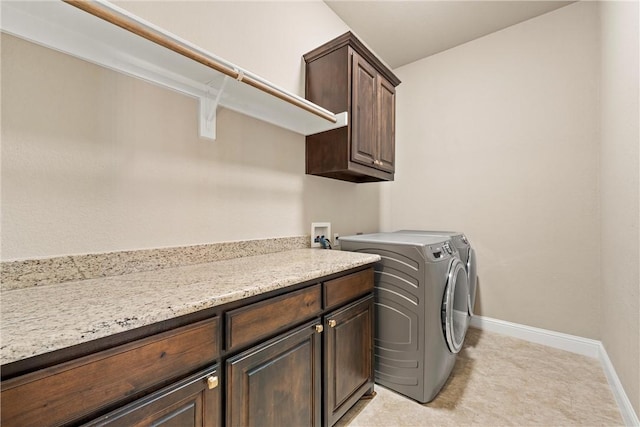 laundry room featuring cabinets and washing machine and clothes dryer