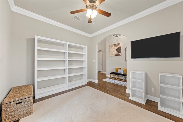 living room featuring hardwood / wood-style flooring, ornamental molding, and ceiling fan