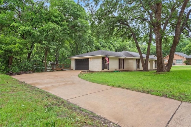 ranch-style house with a garage and a front lawn