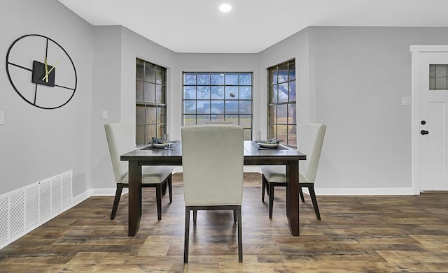 dining room with dark hardwood / wood-style flooring