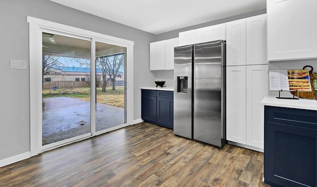 kitchen with white cabinetry, stainless steel fridge, and dark hardwood / wood-style floors