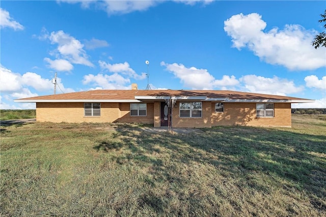 rear view of house with a yard