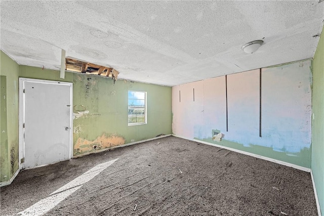 carpeted empty room with a textured ceiling