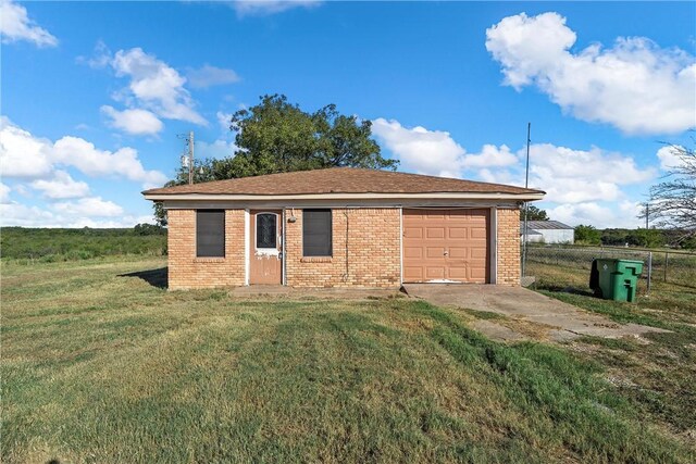 view of outbuilding with a lawn and a garage