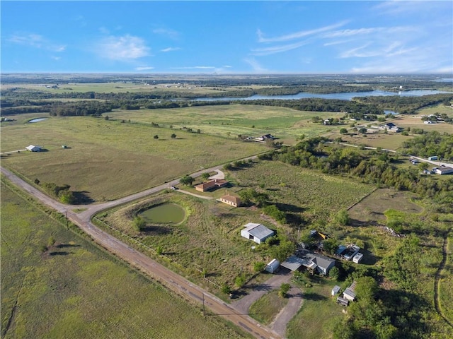 birds eye view of property featuring a rural view and a water view