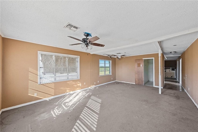 spare room featuring carpet flooring, ceiling fan, and a textured ceiling